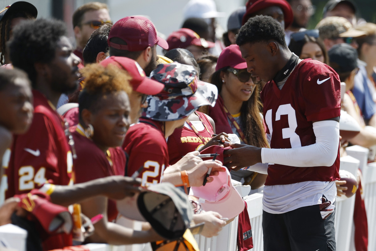 Emmanuel Forbes signs an autograph for Commanders fans